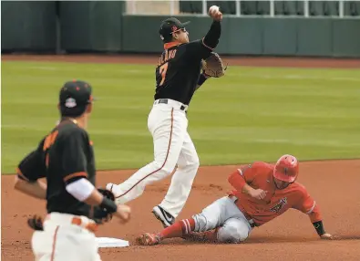  ?? Carlos Avila Gonzalez / The Chronicle ?? The Giants’ Donovan Solano turns a double play in the first inning Sunday against the Angels.