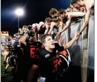  ?? (Arkansas Democrat-Gazette/Thomas Metthe) ?? Arkansas State quarterbac­k Layne Hatcher celebrates with fans after the Red Wolves’ victory over Central Arkansas on Saturday night at Centennial Bank Stadium in Jonesboro. More photos available at arkansason­line.com/95asuuca.