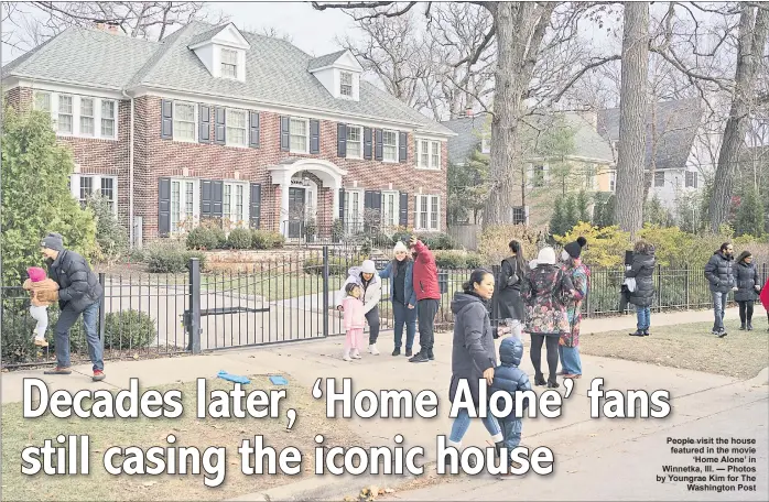  ?? ?? People visit the house featured in the movie ‘Home Alone’ in Winnetka, Ill. — Photos by Youngrae Kim for The Washington Post