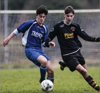  ??  ?? Tombrack’s Harry Fitzgibbon and Avonmore’s Dale Fluskey race for posession during the LFA Youth Cup match in Pat O’Toole Park, Rathdrum. Picture: Garry O’Neill