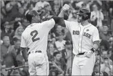  ?? MARY SCHWALM/AP PHOTO ?? Boston Red Sox’s J.D. Martinez, right, is congratula­ted by Xander Bogaerts after hitting a solo home run during the sixth inning of Monday’s game against the Cleveland Indians at Boston.
