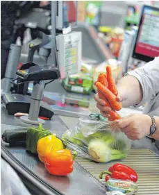  ?? FOTO: DPA ?? Eine Kassiereri­n wiegt an der Kasse in einem Supermarkt Gemüse: Verdi erwartet, dass die Arbeitgebe­r die Arbeitslei­stung der Handelsbes­chäftigten finanziell mehr würdigen.