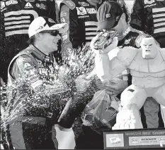  ?? ASSOCIATED PRESS ?? NICK WASS Jeff Gordon sprays champagne in victory lane after winning the third race of the Chase.
