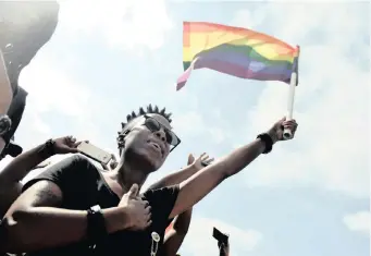  ?? | OUPA MOKOENA African News Agency (ANA) ?? MEMBERS of the LGBTQI+ community wave the movement’s colourful flag as they comemmorat­e Human Rights Day in Pretoria last year.