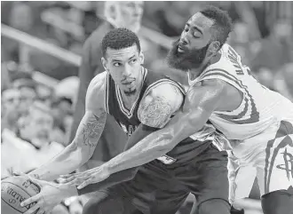  ?? Karen Warren / Houston Chronicle ?? Rockets guard James Harden, right, had little help against guard Danny Green and the Spurs in Friday night’s 103-92 loss in Game 3 at Toyota Center.