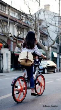  ??  ?? Mobikes have appeared in China’s capital Riding a Mobike