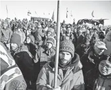  ?? BRIAN POWERS, DES MOINES REGISTER ?? People gather at an interfaith prayer circle Sunday in the Oceti Sakowin Camp near the Standing Rock Reservatio­n near Cannon Ball, N.D.