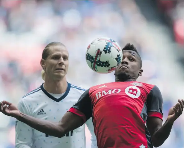  ?? — CP ?? Whitecaps midfielder Brek Shea looks on as Toronto FC’s Armando Cooper plays the ball during the first half of Saturday’s game. Shea was red-carded in the 69th minute for something he said to the referee and Toronto scored two goals shortly after en...