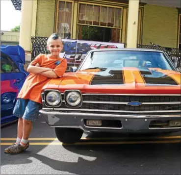  ?? JESI YOST — FOR DIGITAL FIRST MEDIA ?? Seven-year-old Dalton Batzel of Pottsgrove Elementary School with a 1969 Chevy Chevelle. Boyertown’s 9th Annual Cruise Night kicked off Saturday along Reading Avenue.