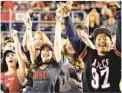  ??  ?? SDSU Aztecs fans celebrate after the team takes a huge lead against San Jose State in October 2016 at Qualcomm Stadium.