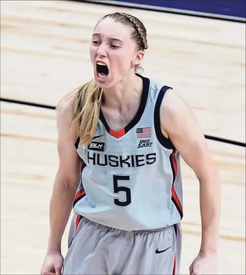  ?? Eric Gay / Associated Press ?? UConn guard Paige Bueckers celebrates a score against Baylor during the second half of their Elite Eight game Monday in the NCAA Tournament. Bueckers led all scorers with 28 points in the Huskies’ victory.