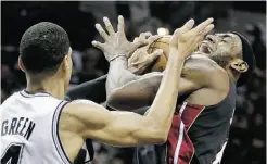  ?? ERIC GAY/ THE ASSOCIATED PRESS ?? Miami’s LeBron James is defended by Danny Green during Game 5 of the NBA Finals Sunday. San Antonio won 114-104.