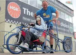  ??  ?? Graham Inchley and daughter Isla with the endurance wheelchair he will use in his TT course bid.