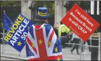  ?? The Associated Press ?? FADING FAST: Anti-Brexit campaigner Steve Bray walks near Parliament in London, Tuesday. The British government said Tuesday that the chances of a Brexit deal with the European Union were fading fast, as the two sides remained unwilling to shift from their entrenched positions.