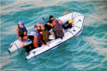  ?? AP ?? Migrants aboard a rubber boat wait for rescue after being intercepte­d by French authoritie­s off the port of Calais, northern France.