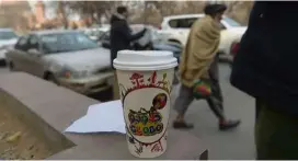  ??  ?? A cup of coffee from Najibullah’s cart.