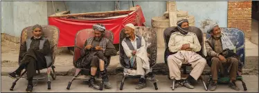  ?? (AP/Bernat Armangue) ?? Laborers wait in the street to be hired Sept. 12 in Kabul.