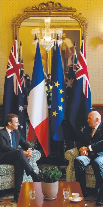  ?? OFFICIAL TRIP: French President Emmanuel Macron ( above left) speaks with the Governor- General of Australia Peter Cosgrove in Sydney yesterday and ( right) Mr Macron presents the Legion d’Honneur award to Australian William Mackay. He was one of three Au ??