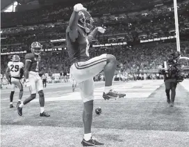  ?? KEVIN C. COX Getty Images ?? Alabama’s John Metchie III celebrates after scoring a touchdown in the second quarter of the SEC Championsh­ip game Saturday against Georgia in Atlanta.