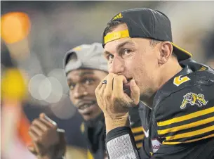  ?? PETER POWER/THE CANADIAN PRESS ?? While signing former NFL quarterbac­k Johnny Manziel, right, brought the Hamilton Tiger-Cats a publicity boost, adding players with name recognitio­n is not sound business strategy for the CFL.