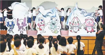  ??  ?? A shortlist of three pairs of official Tokyo 2020 Olympic Games mascots are unveiled at Kakezuka elementary school in Tokyo. — AFP photo