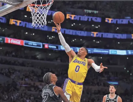  ?? KIRBY LEE/USA TODAY SPORTS ?? Former Lakers guard Russell Westbrook shoots against the Spurs on Jan. 25. The Lakers traded Westbrook to the Jazz and reacquired guard D’angelo Russell from Minnesota in a three-team deal last week.