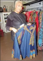  ??  ?? Brenda Mitchell shows off the ankara skirts she sells at J. Mitchell’s Hair & Boutique in Little Rock. Mitchell says she gets an increase in customers seeking such attire for Black History Month programs.