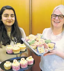 ??  ?? Preeti Sharma and Vicky Reid with some of the tasty treats from the cake and candy stall.