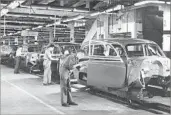  ?? Associated Press ?? AUTO WORKERS at the end of the assembly line at General Motors’ plant in Euclid, Ohio, in 1950.