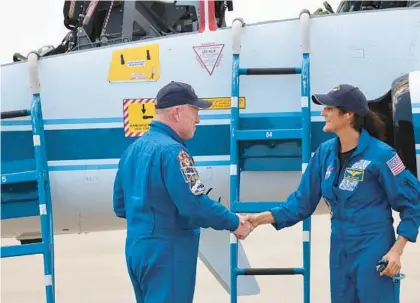  ?? RICARDO RAMIREZ BUXEDA/ORLANDO SENTINEL ?? NASA astronauts Butch Wilmore, from left, and Suni Williams, shake hands on Thursday after arriving at Kennedy Space Center aboard T-38 aircraft, for the Starliner Crew Flight Test.