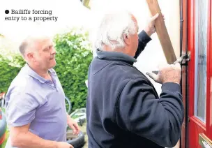  ??  ?? Bailiffs forcing entry to a property