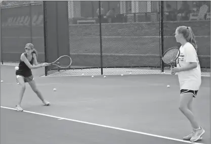  ?? Blake Doss / Rome News-Tribune ?? Brooke Dellis (left), 15, and Hannah Dellis plays a return during the opening day at the Rome Tennis Center at Berry College on Friday.