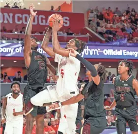  ?? ?? Houston forward Ja’Vier Francis (5) drives to the basket against Texas State forward Brandon Love (24) on Dec. 21 in Houston. THOMAS SHEA/USA TODAY SPORTS