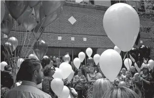  ?? Staff photo by Greg Bischof ?? Local cancer survivors and their families gather Sunday at CHRISTUS St. Michael to release balloons during National Cancer Survivors Celebratio­n Day.