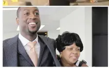  ?? | AP FILE PHOTO ?? DwyaneWade’s mother, JolindaWad­e, shown with her son in 2010, identified the victim of a shooting Friday as her niece.
