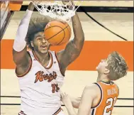  ?? Getty Images ?? SLAMMED SHUT: Myles Johnson dunks as Marek Dolezaj defends during the first half of Rutgers’ 79-69 victory over Syracuse.