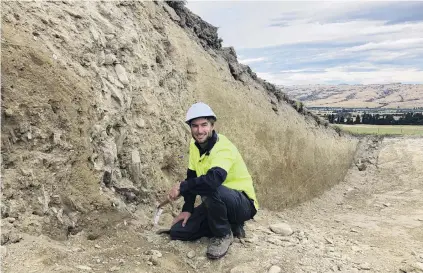  ?? PHOTO: GUY FREDERICK ?? Digging deeper . . . University of Otago geology PhD student Jonathan Griffin works on the Hyde Fault, at the foot of the Rock and Pillar Range. The Taieri Ridge can be seen to the east.