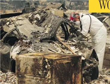  ?? JOHN LOCHER / THE ASSOCIATED PRESS ?? A search-and-rescue worker looks for human remains at a trailer park in Paradise, Calif., on Tuesday.