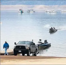  ?? Brian van der Brug Los Angeles Times ?? FISHERMEN pull out boats at Bidwell Canyon Marina on Lake Oroville, which has risen more than 27 feet since the rains began.