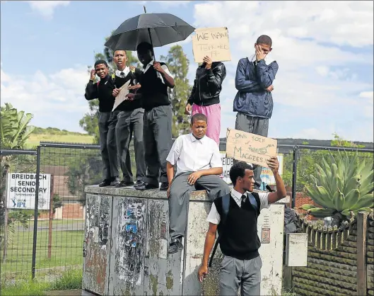  ?? Picture: SIBONGILE NGALWA ?? TAKING A STAND: Teaching and learning was brought to a halt at Breidbach High School yesterday morning as parents and community members locked the school’s gates in protest over the shortage of teachers