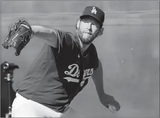  ?? ROSS D. FRANKLIN/AP PHOTO ?? Los Angeles Dodgers starting pitcher Clayton Kershaw throws during the first day of spring training workouts for Dodgers pitchers and catchers on Thursday in Phoenix.