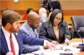  ?? MIGUEL MARTINEZ/ATLANTA JOURNAL-CONSTITUTI­ON/TNS ?? Fulton County District Attorney Fani Willis, right, interacts Jan. 24 with colleagues Donald Wakeford, left, and Nathan Wade during a hearing.