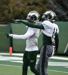  ?? Eddie Herz, Loveland Reporter-herald ?? Colorado State junior receiver Tory Horton (right) chats with fellow wideout E.J. Scott during spring practice outside Canvas Stadium last week.