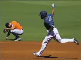  ?? GREGORY BULL — THE ASSOCIATED PRESS ?? The Rays’ Manuel Margot rounds the bases past the Astros’ Jose Altuve after hitting a three-run home run against starting pitcher Lance McCullers Jr. in Game 2 of the ALCS.