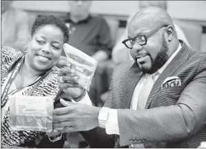  ?? JIM WEBER THE COMMERCIAL APPEAL ?? Memphis City Council member Jamita Swearengen (left) passes a bag of marijuana to council member Berlin Boyd Tuesday. Police Director Michael Rallings handed out the marijuana to demonstrat­e what a “small amount” of marijuana means in real terms. Boyd...
