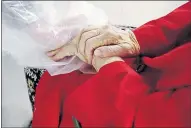  ??  ?? Gregg MacDonald holds hands with his 84-year-old mother, Chloe MacDonald, at a “hug tent” set up outside the Juniper Village assisted living center in Louisville, Colo.