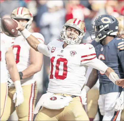  ?? KAMIL KRZACZYNSK­I — THE ASSOCIATED PRESS ?? Quarterbac­k Jimmy Garoppolo is elated after scoring one of his two rushing touchdowns in the 49ers’ 33-22 victory over the Chicago Bears on Sunday afternoon at Soldier Field. Garoppolo also completed 17 of 28 passes for 322 yards with no intercepti­ons.