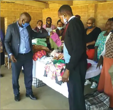  ??  ?? Picture: Nizbert Moyo
Bulawayo mayor Solomon Mguni and ward 25 councillor Mzana Dube inspect some of the items donated to a child whose mother died while giving birth in Figtree and was left in the custody of his father. The donation was sourced by ward 25 women.