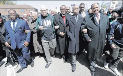  ?? Mark Humphrey ?? The Associated Press Martin Luther King III, right, and the Rev. Al Sharpton, second from right, join Wednesday in a march commemorat­ing the anniversar­y of the assassinat­ion of the Rev. Martin Luther King Jr. in Memphis, Tenn. Martin Luther King Jr....