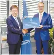 ?? Courtesy of KAERI ?? KAERI President Park Won-seok, left, receives an Internatio­nal Centre based on Research Reactors (ICERR) designatio­n letter from IAI Acting Director General Cornel Feruta, right, on the sidelines of the nuclear energy control body’s conference in Vienna, Tuesday.